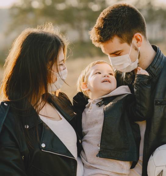 Family wearing face masks with baby during COVID-19 outbreak