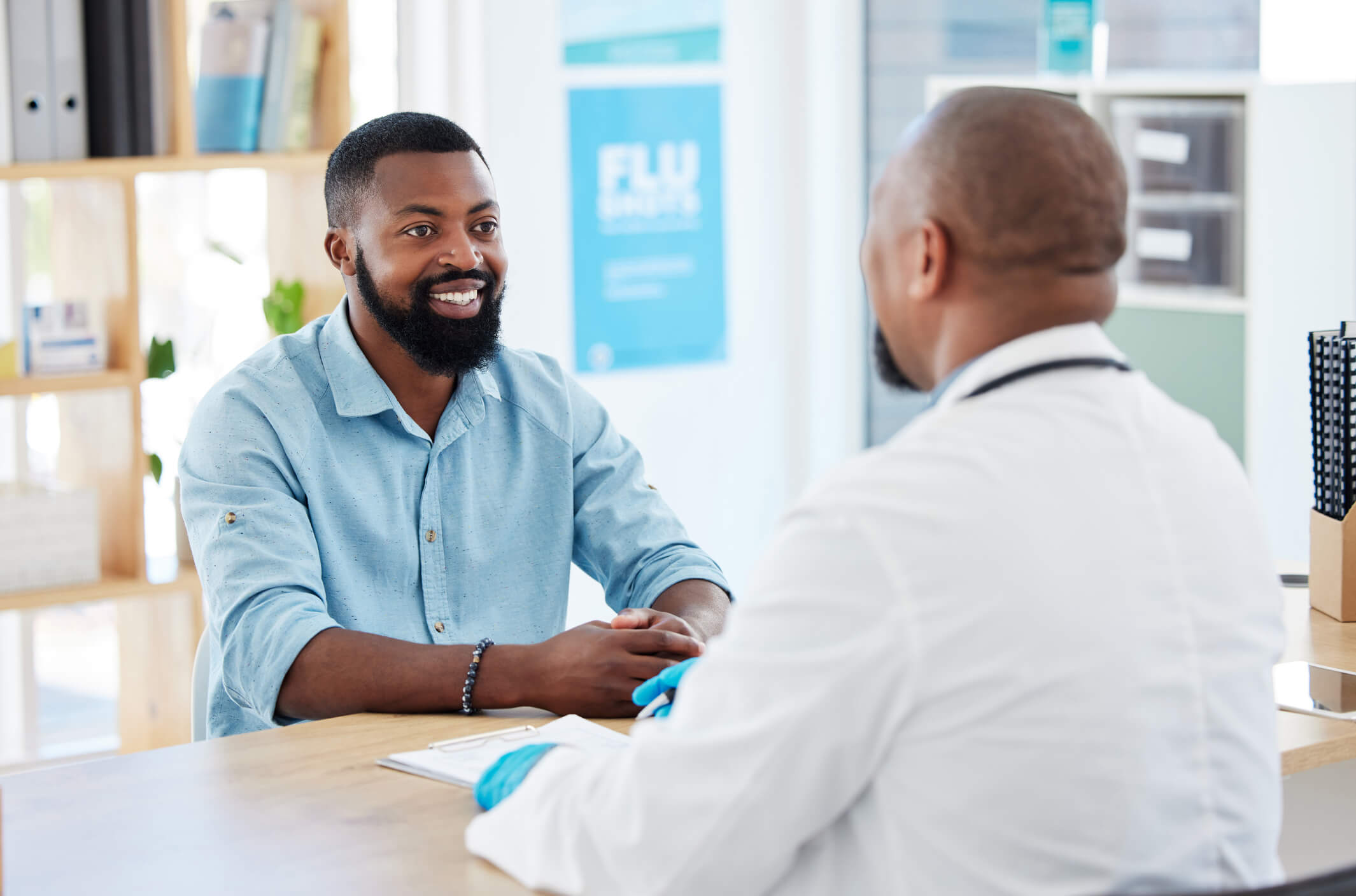 African American male patient talking to an African American male physician..