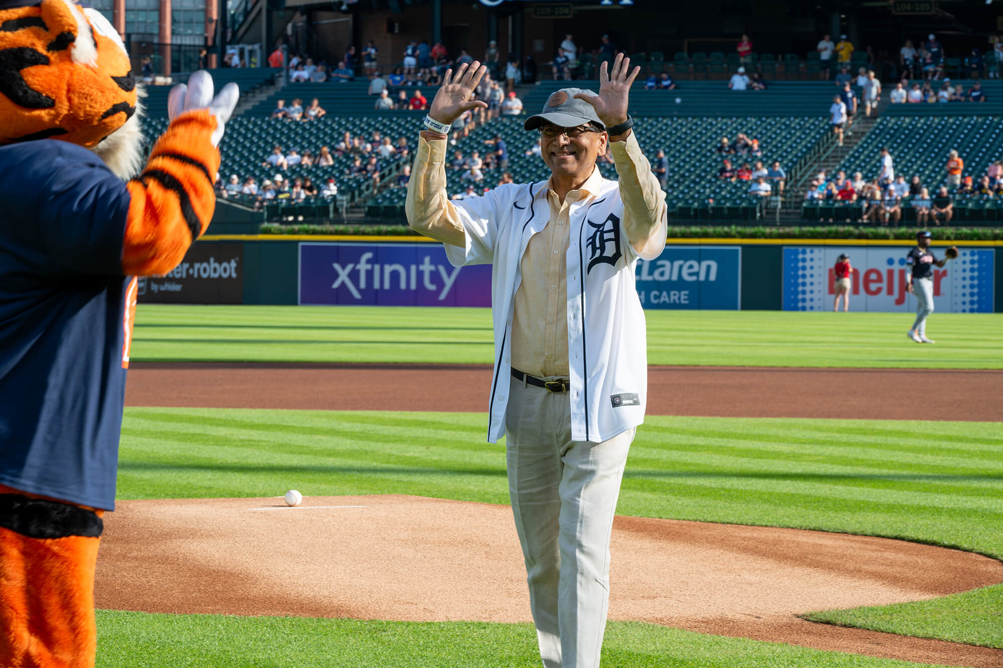 Suneel Sekhri delivers the game ball to the pitcher's mound during the Prostate Cancer Awareness Night game.
