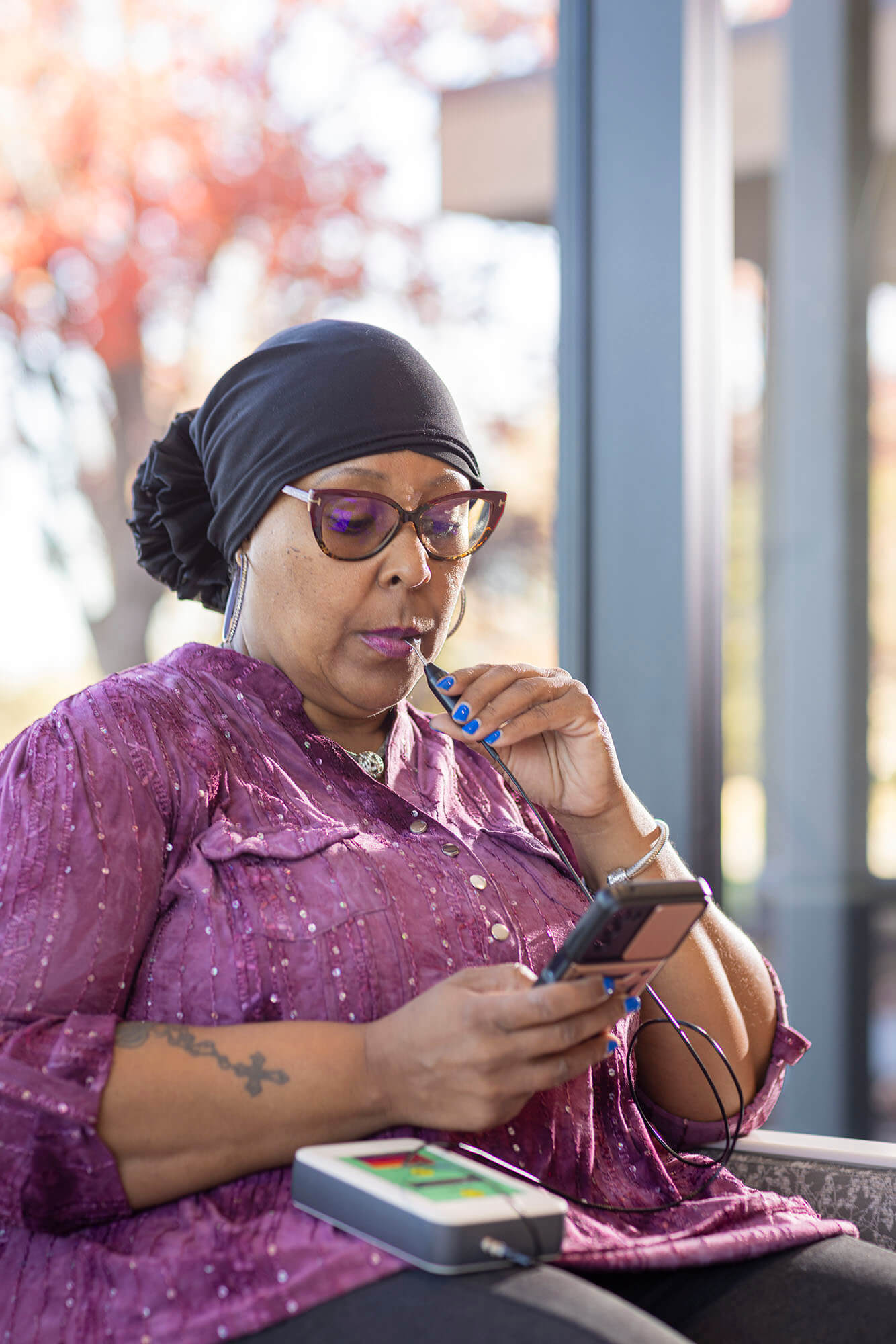 Patient delivering treatment with the TheraBionic P1 device.