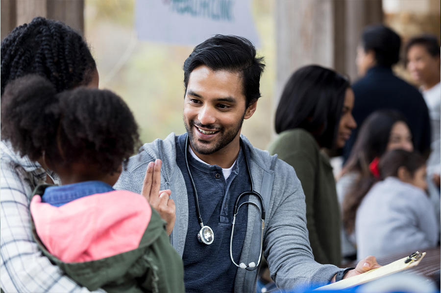 McLaren Physician using sign language to care for young girl and mother