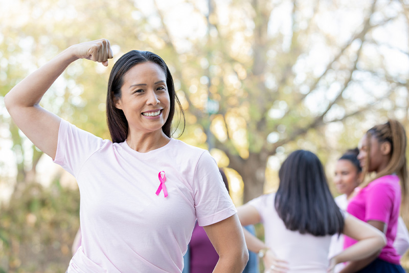 woman flexing wearing pink ribbon