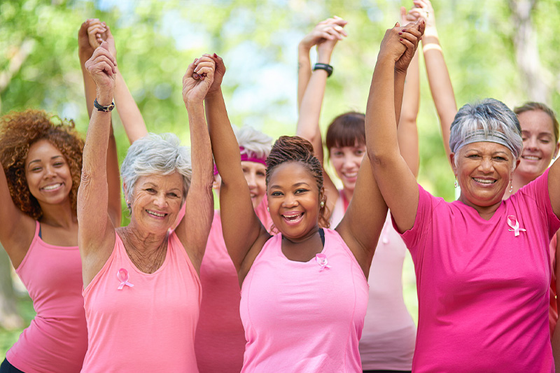 women cheering in pink shirts